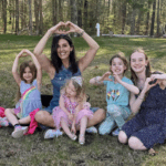 Summer campers with Maria and heart hands